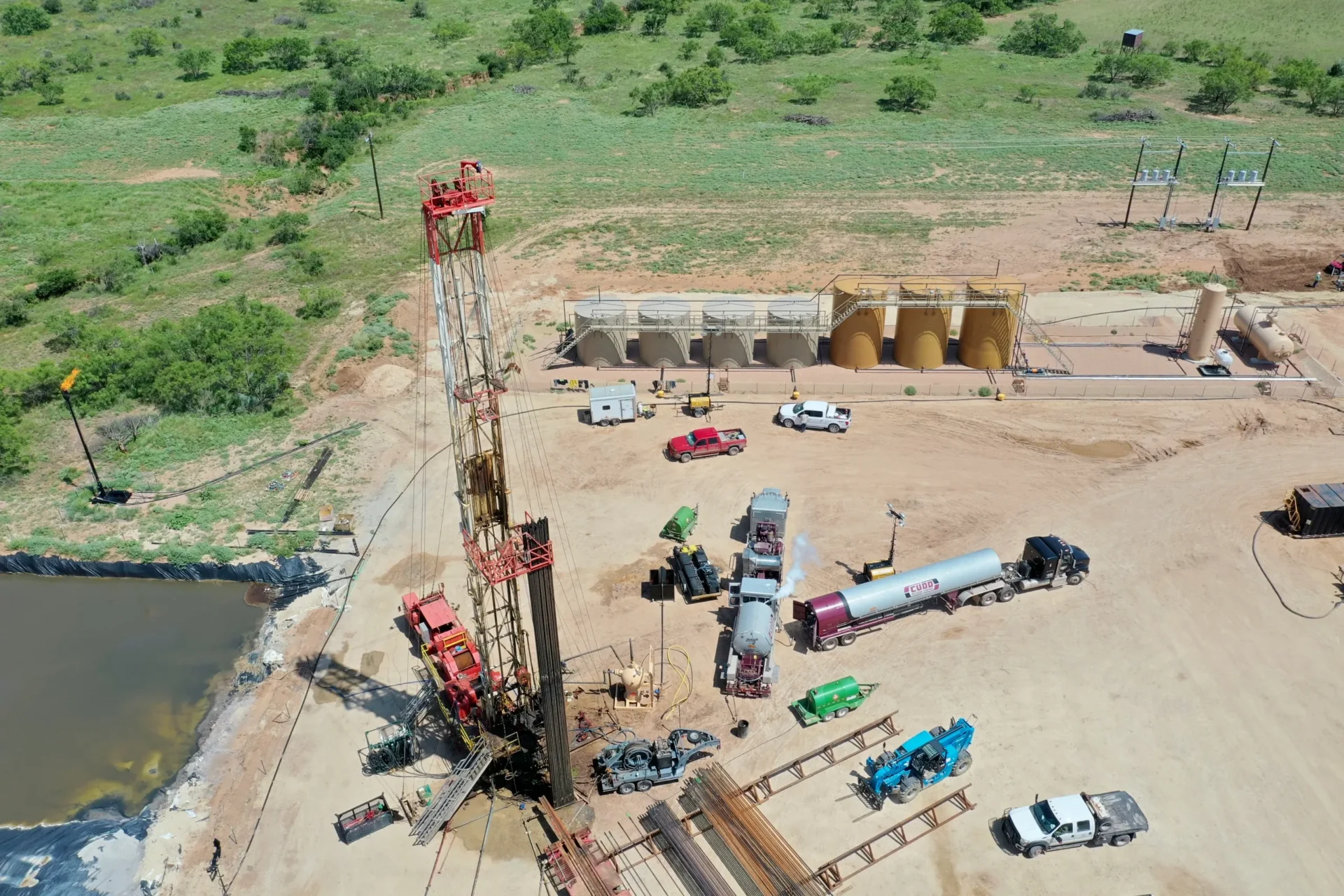 A drilling rig in the middle of an open field.