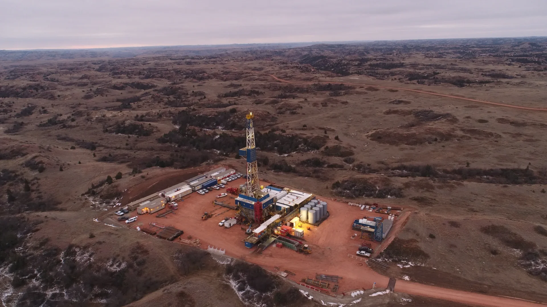 An aerial view of a drilling rig in the middle of nowhere.