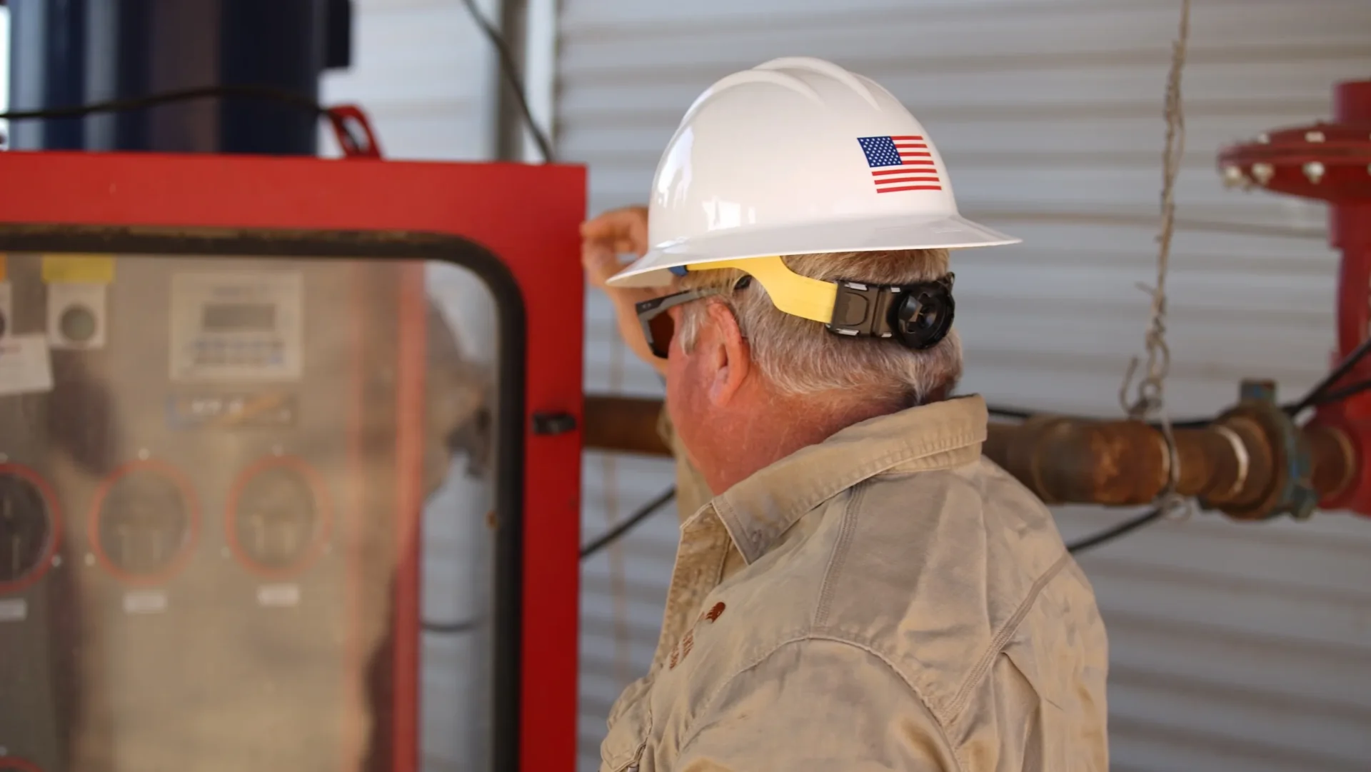 A man wearing an american flag hard hat.