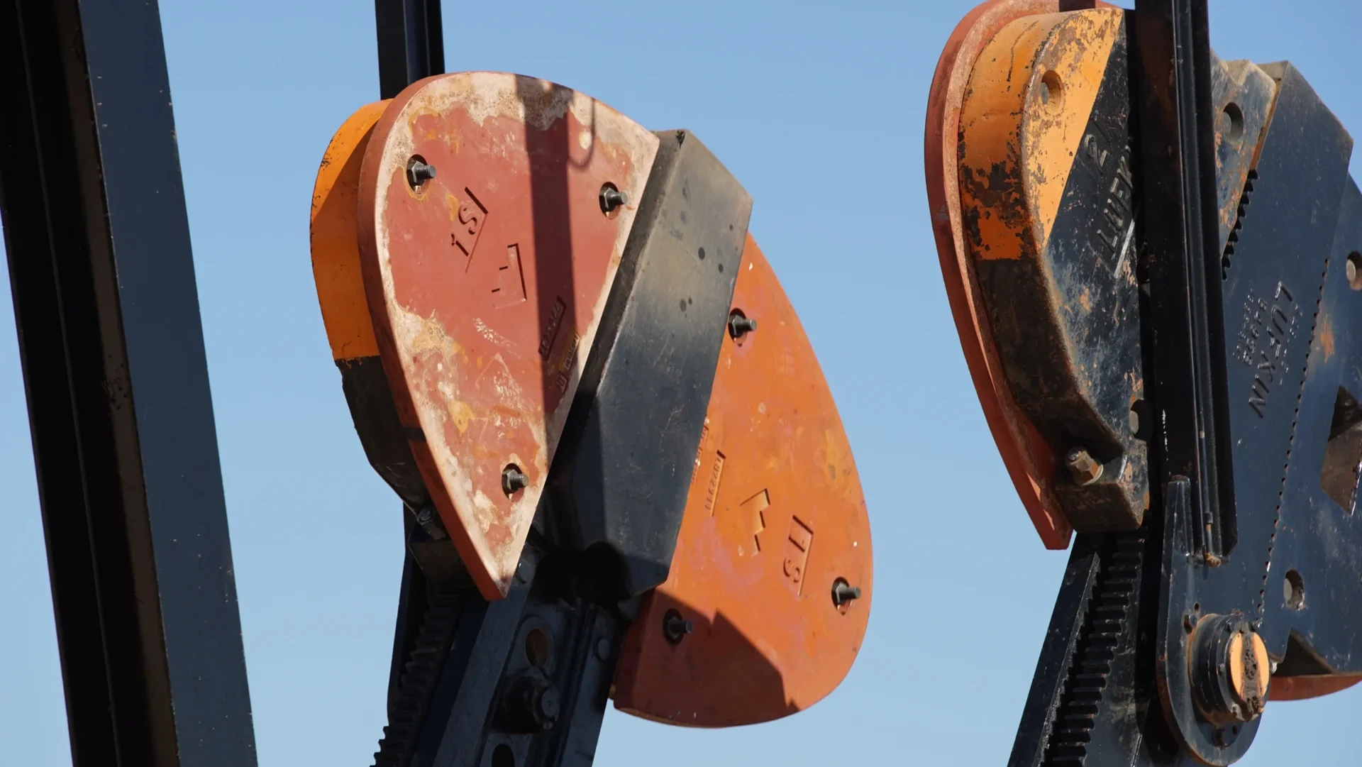 A close up of two orange and black traffic lights.