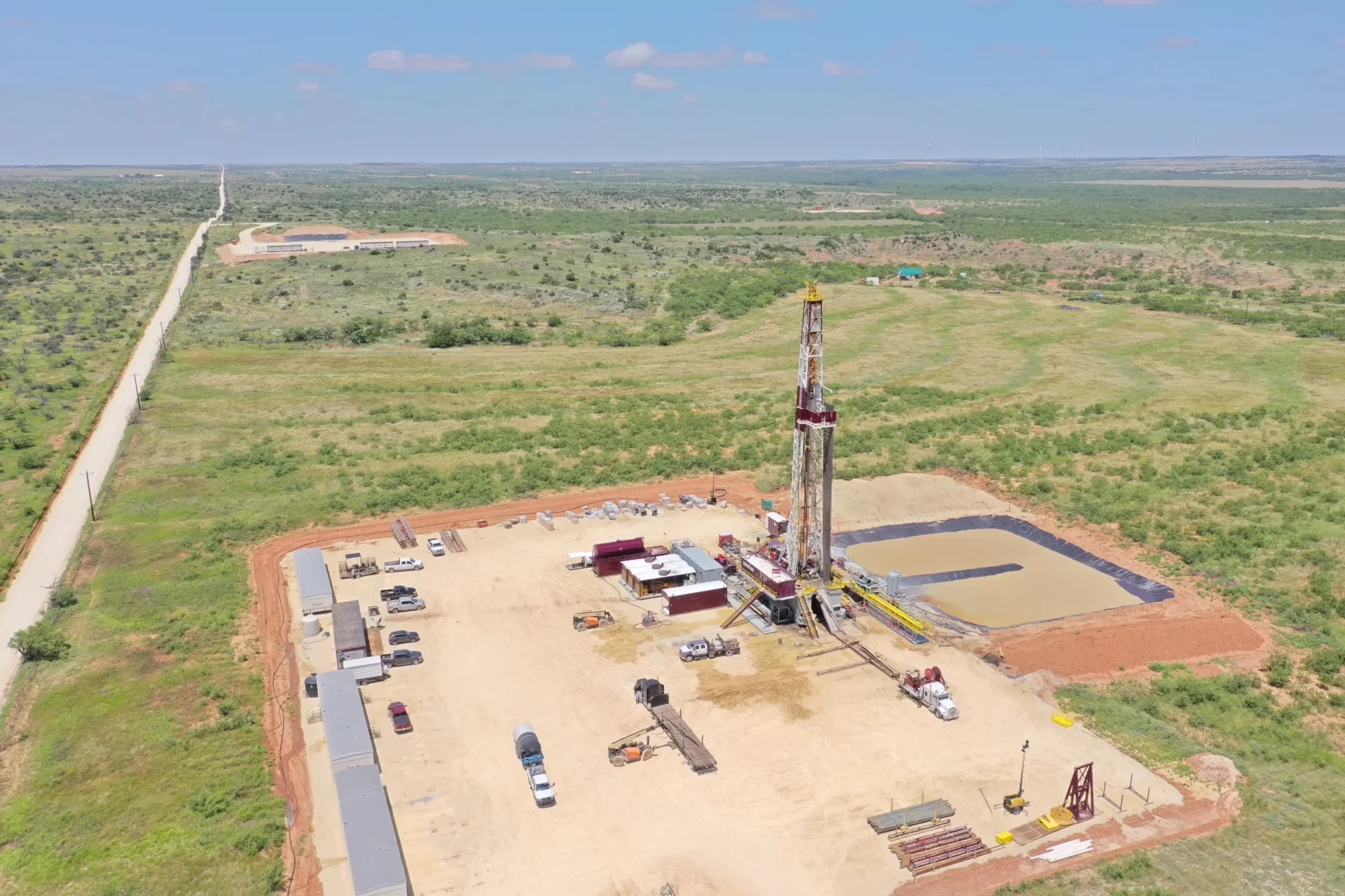 An aerial view of a drilling rig in the middle of nowhere.